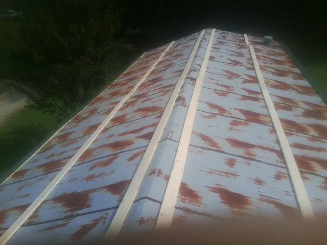 Rusted metal roof panels with new wood purlins before replacement — Storm Damage Roof Repair in Oaks by Roofing Brothers