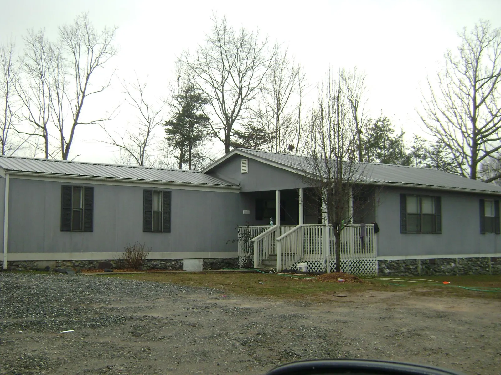Metal roof over a manufactured home with a covered front porch in Oaks